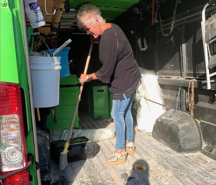 Owner sweeping out dirty van