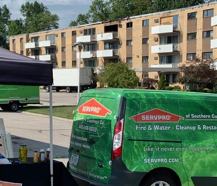 SERVPRO vehicles in front of apartments that has fire damage